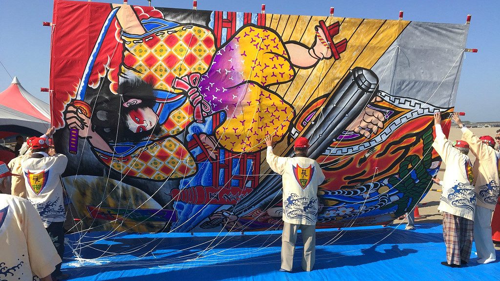 A kite on the ground for size comparison, at the Peaceful World Kite Festival in Uchinada, Japan