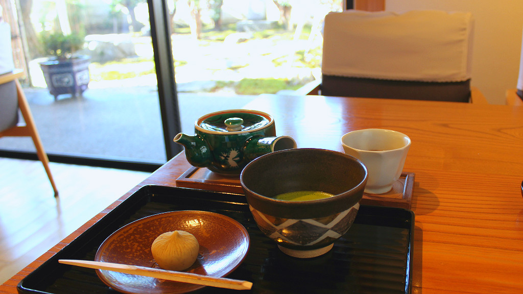 Matcha green tea, houjicha, and traditional wagashi Japanese sweet in geisha district cafe