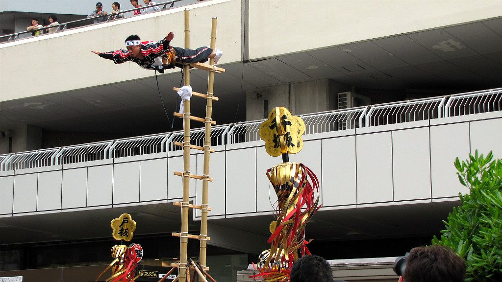 Kaga Firefighters show off their acrobatic skill during the Hyakumangoku Festival Parade