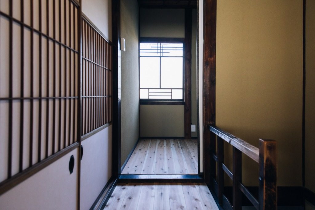 Sliding doors, wood floors, and shoji paper windows are common in traditional machiya homes in Japan