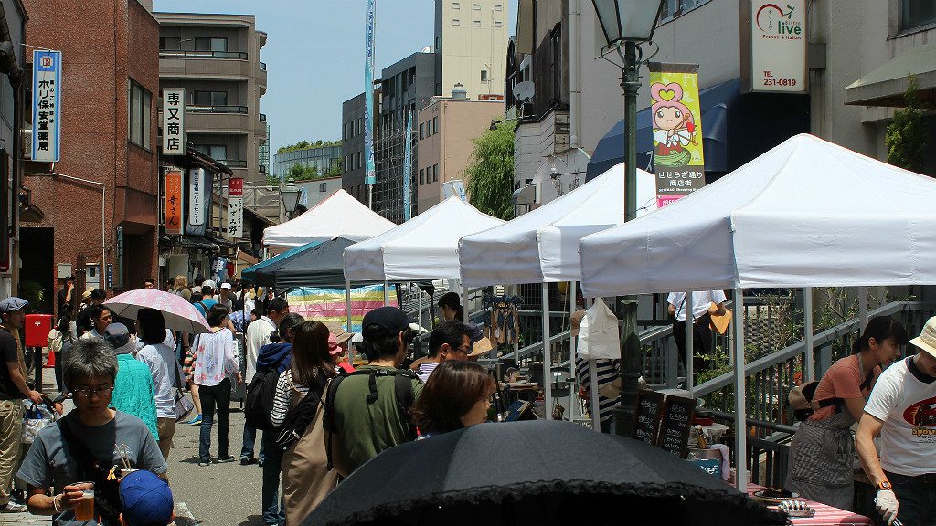 Food and flea market booths line Seseragi Street for the Marraige Festival in Kanazawa, Japan