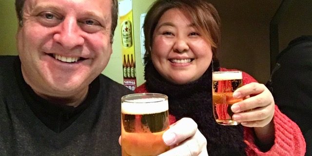 Andrew Blechman and friend Akiko sharing a beer in Kanazawa, Japan