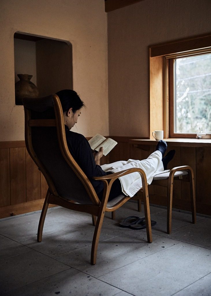 Relaxing with a book in Yuyado Sakamoto's guestroom in the Noto, north of Kanazawa, Japan