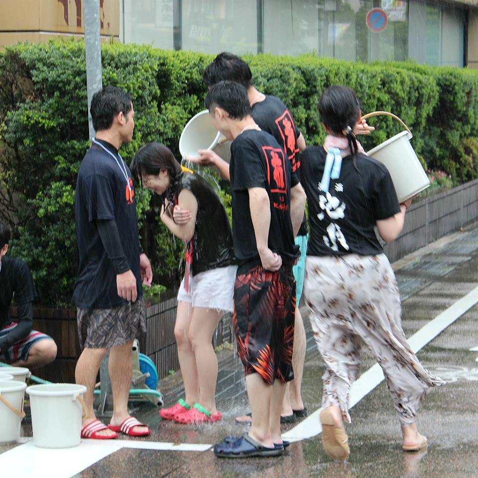 Pouring water at Kakinokibatake's Mizukake Festival in Kanazawa, Japan