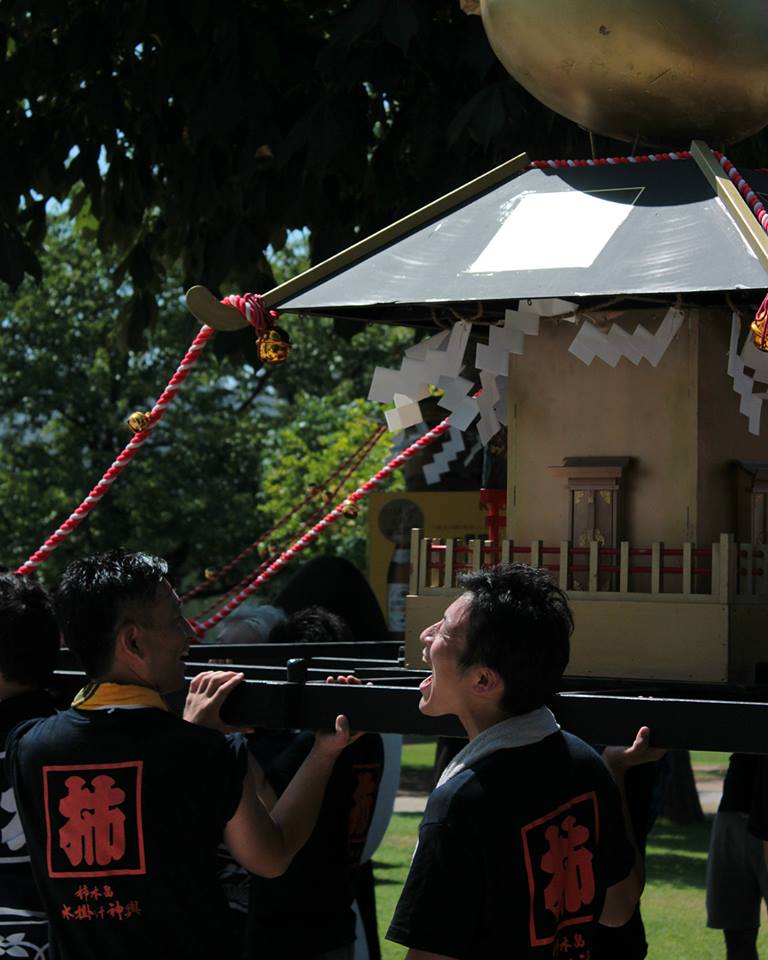 Cheers under the mikoshi shrine in Kanazawa