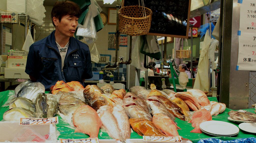 Fish seller at Omicho Market in Kanazawa, Japan