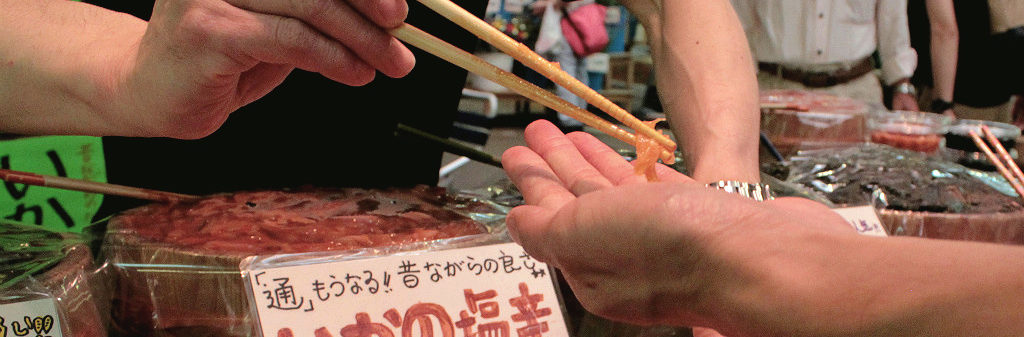 Snacking on samples in Omicho Fish Market in Kanazawa, Japan