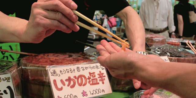 Snacking on samples in Omicho Fish Market in Kanazawa, Japan