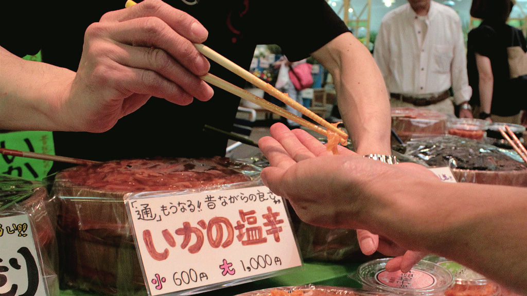Snacking on samples in Omicho Fish Market in Kanazawa, Japan