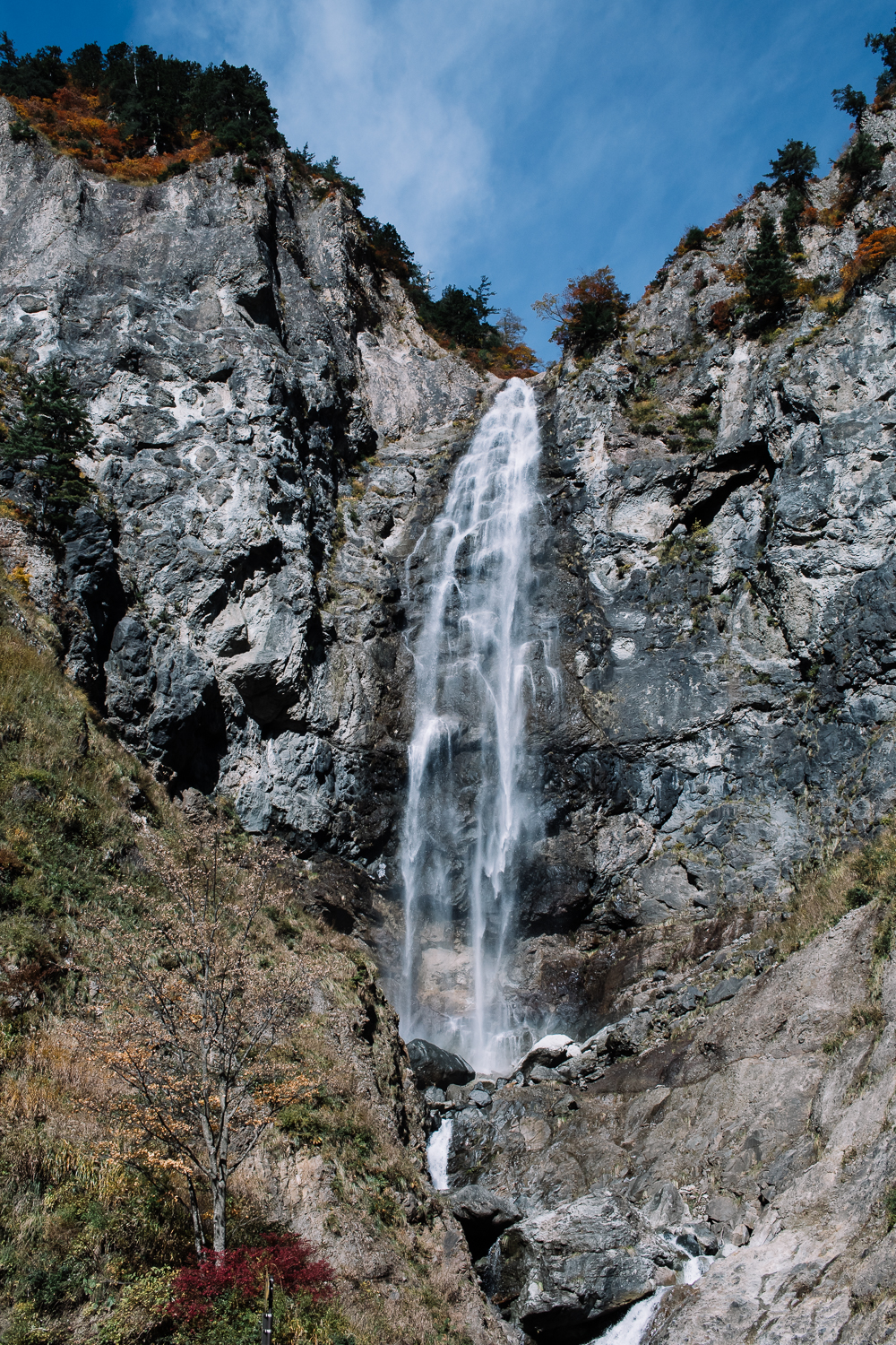 Waterfall against blue rock along the White Road, the scenic highway to Shirakawa-go.