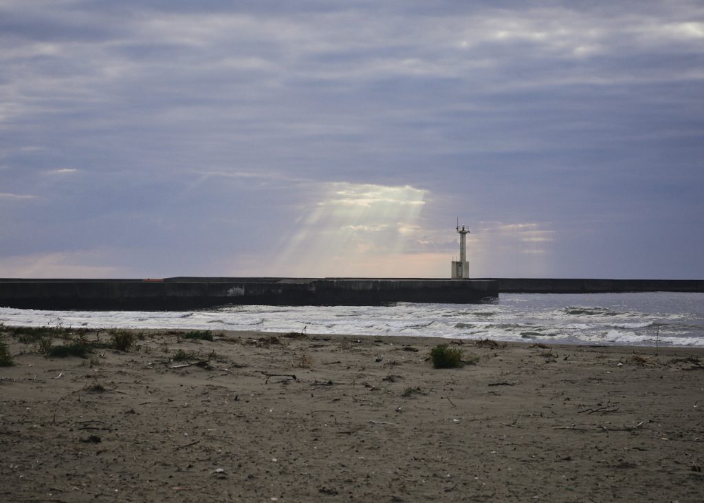 Cloudy sun setting over the leves of Kanaiwa's beach, in Kanazawa, Japan.