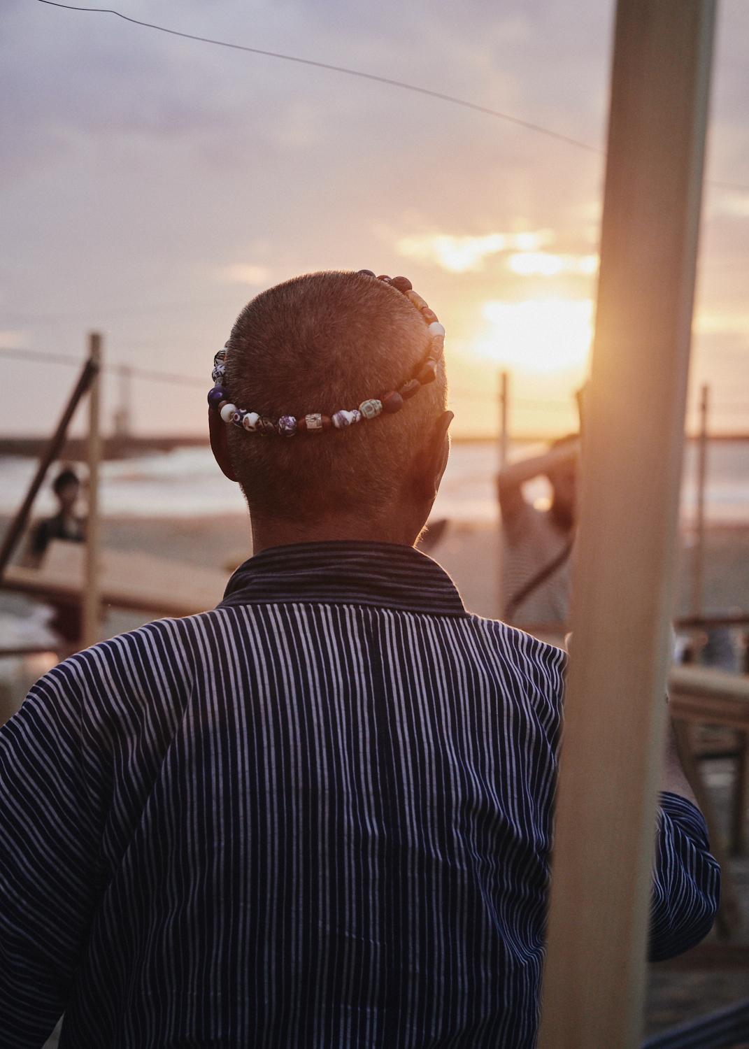 The pottery master, Seppou Iida, surveys the baking grounds as the sun sets on Kanaiwa Beach in Kanazawa, Japan