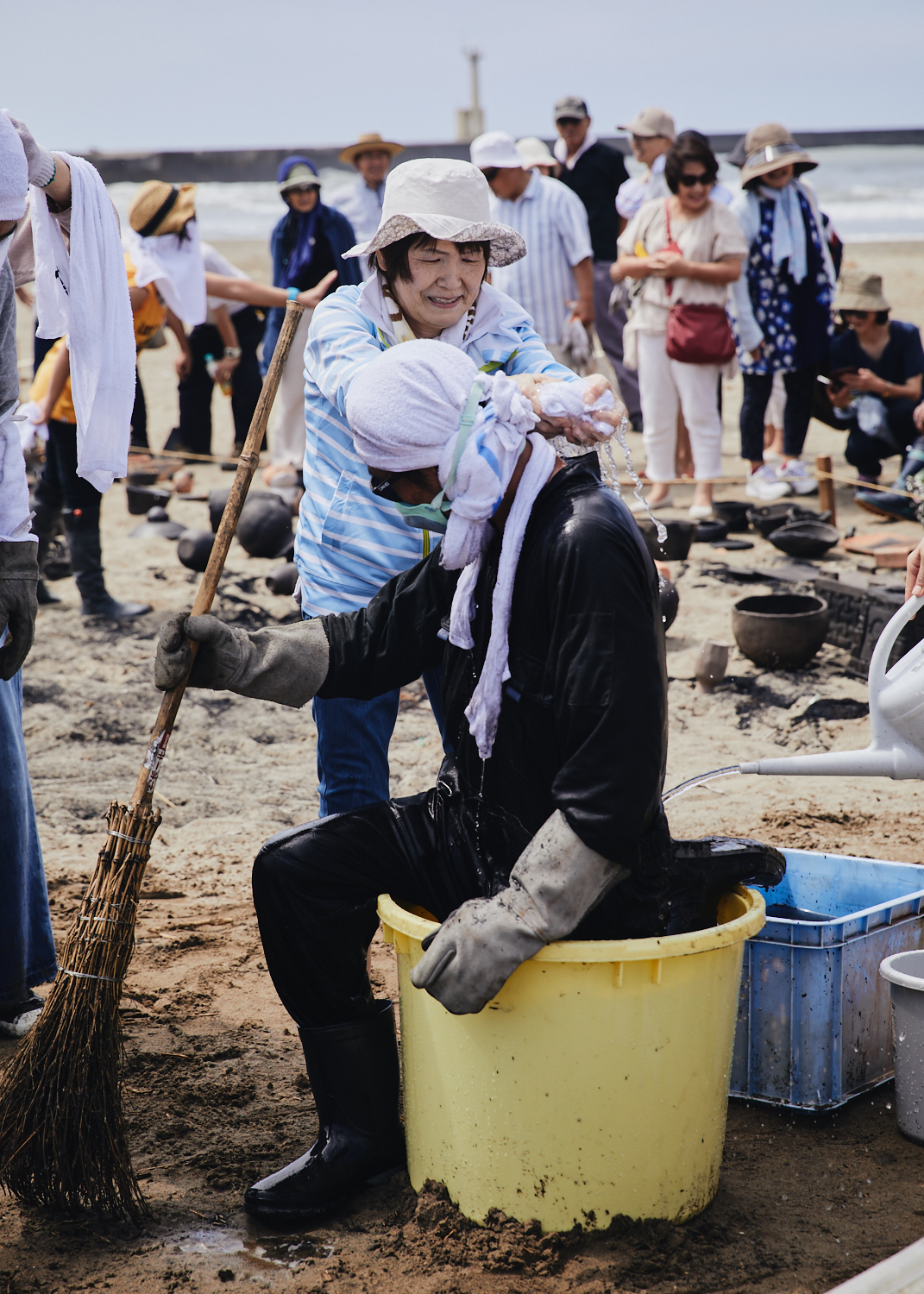 Man dips himself in water to cool and protect himself from fire during the wild fire earthenware baking event in Kanazawa, Noyaki.