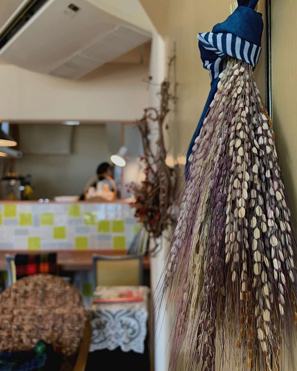 Dried buff and dark purple grains hang from the wall at Ihanoha Vegan Cafe in Kanazawa, Japan