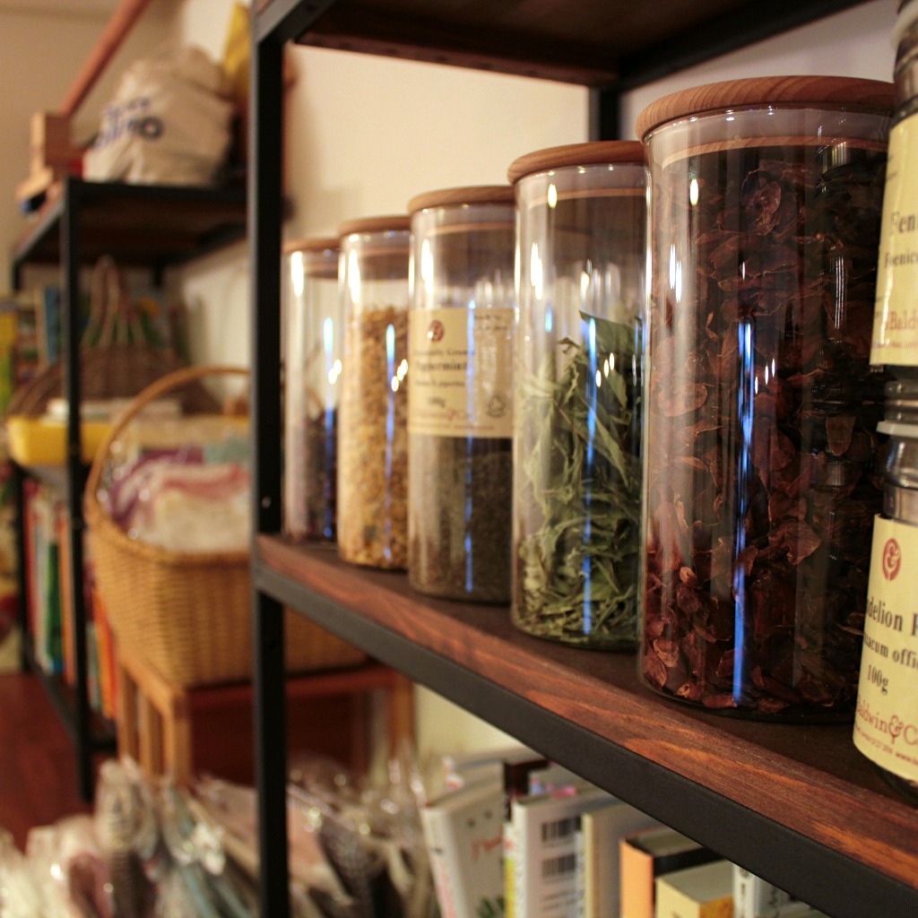 Spice racks and bookshelves in Taste & Scent, a veggie-friendly cafe in Kanazawa, Japan