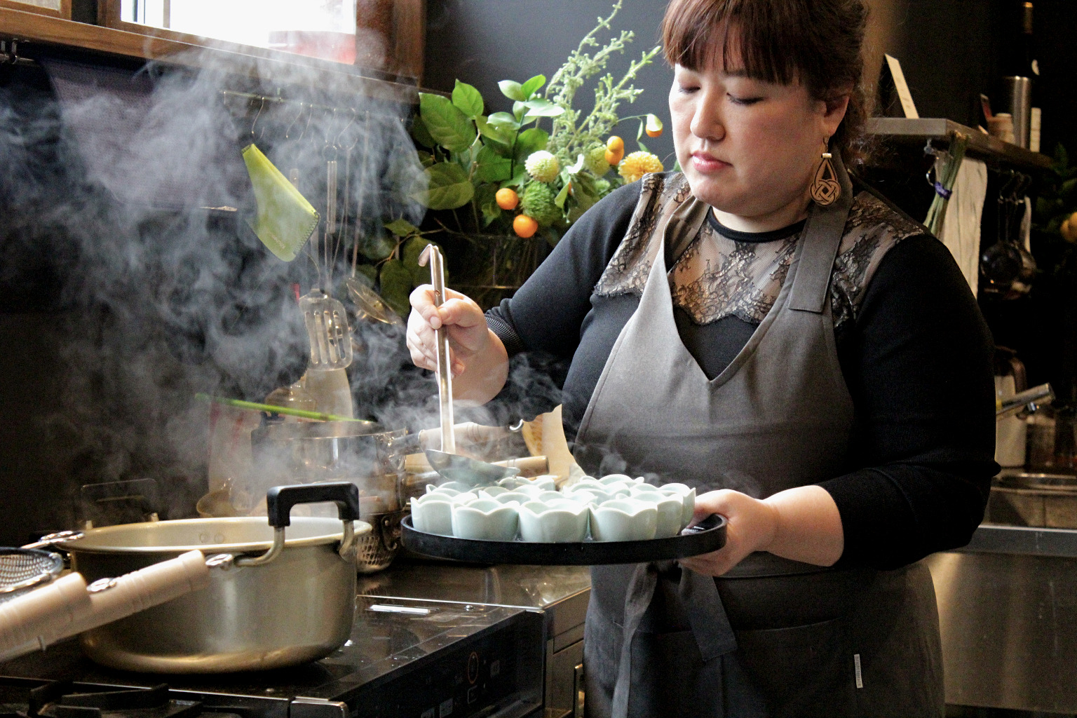 Naoko dishes out some freshly cooked fish cake dumpling soup during her cooking class in Kanazawa, Japan