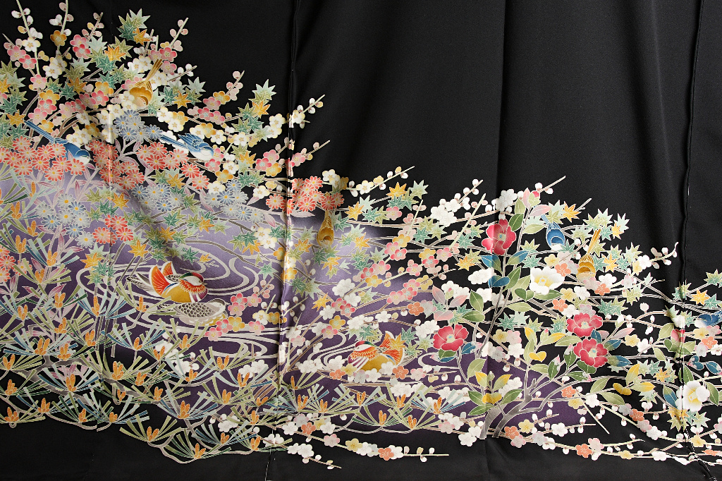 The bottom half of a fully open formal kimono, with a black background and kaga-yuzen imagery